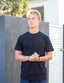 Man wearing black coloured tshirt with black embroidered design 