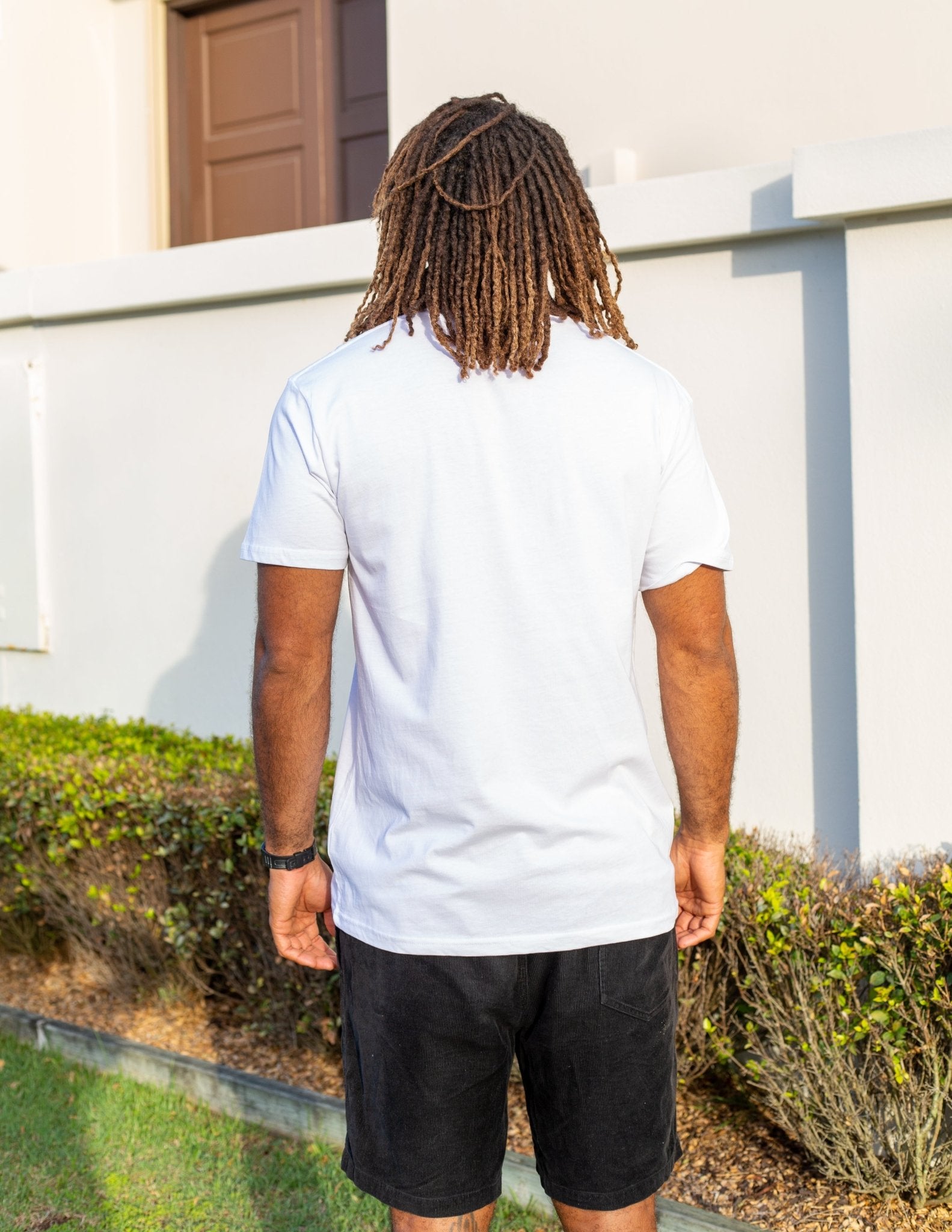 Man wearing white coloured tshirt with black embroidered design 